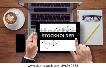 STOCKHOLDER CONCEPT , on the tablet pc screen held by businessman hands - online, top view