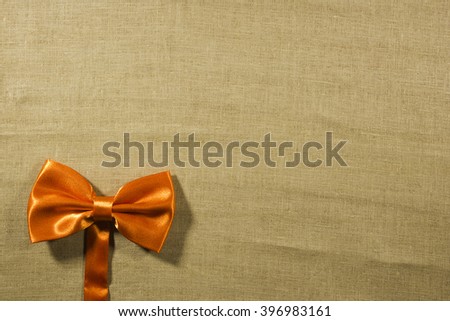 Bow tie on a background of white linen napkins