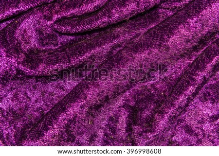 The texture, background draped purple velvet fabric