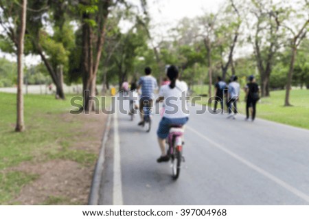 blurred people riding bicycle in the park