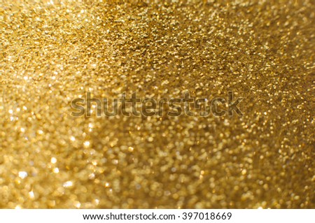 Abstract defocused background with glittering golden particles