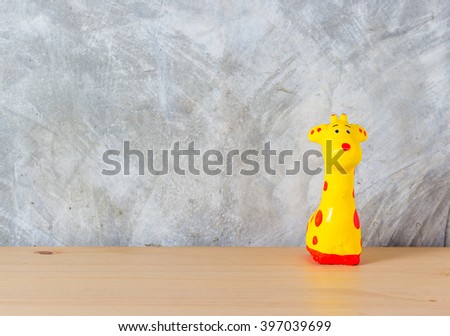 Giraffe toy over wooden table,with copy space.