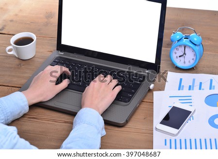 Businessman sitting in front of computer monitor and analyzing data