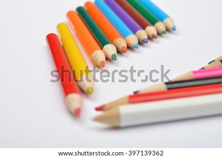 Close up picture of many little colored pencil crayons on white background. Assortment of sharpened colored pencils/ Colored drawing pencils. Selective focus. Copy space