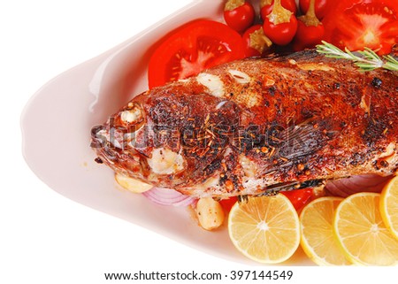 savory: whole fryed sunfish over plate with tomatoes lemons and peppers
