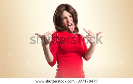 Pretty woman making horn gesture