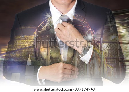 Double exposure of businessman held necktie dress to look good and oil refinery Factory at night as Business and Energy concept.