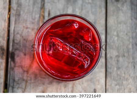 Refreshing Red Soda with Ice on a wooden background Royalty-Free Stock Photo #397221649