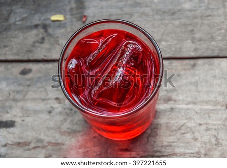 Refreshing Red Soda with Ice on a wooden background Royalty-Free Stock Photo #397221655