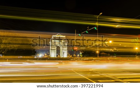 A wide angle long exposure shot of India Gate (formerly known as the All India War Memorial) with light trails of moving vehicles at Rajpath road, New Delhi, India. Royalty-Free Stock Photo #397221994