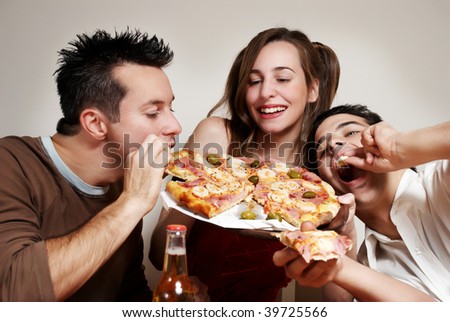 The cheerful company of youth eating a pizza Royalty-Free Stock Photo #39725566