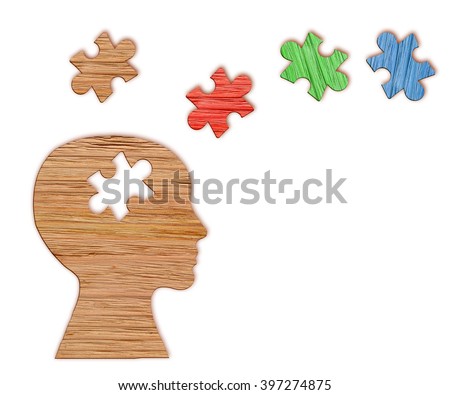 Mental health symbol. Human head silhouette with a puzzle cut out from wooden background Royalty-Free Stock Photo #397274875