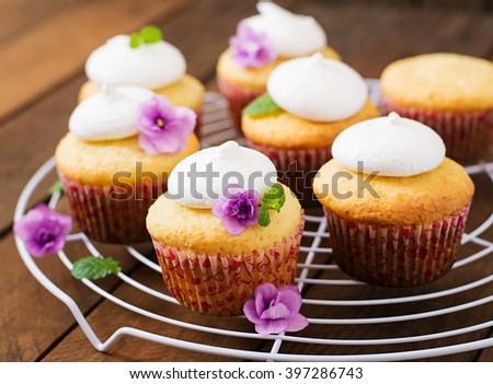 Cottage cheese cupcakes with meringue decorated flower and mint leaves