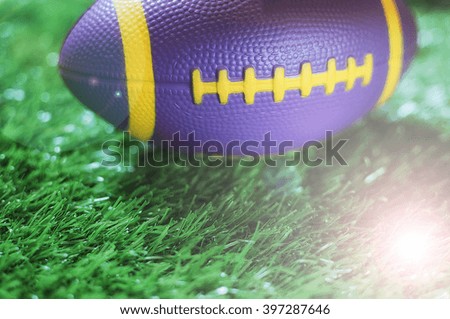 Healthiness concept and sport background idea, Close up of mini American football on the green grass