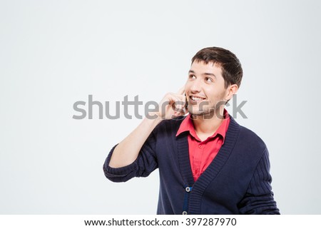 Happy man talking on the phone and looking away isolated on a white background