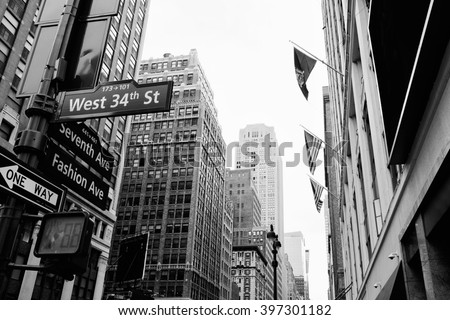 Manhattan beautiful street view with big buildings and flags, New York, USA. Financial district. Business and travel background. Black and white postcard.