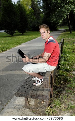 Picture of young man with notebook in park