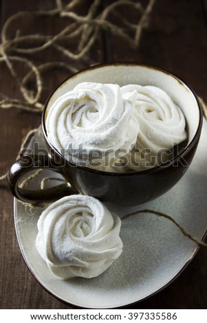 Russian Rose Swirl Marshmallow in a cup on a dark wooden background