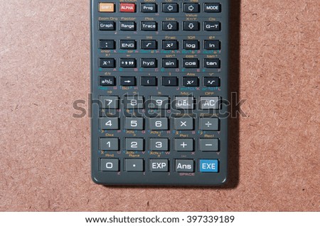 Calculator on wooden board.