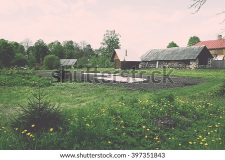 countryside buildings in summer in small village - vintage film effect