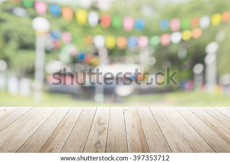 Empty wooden table with blurred party on background,  fun / spring concept