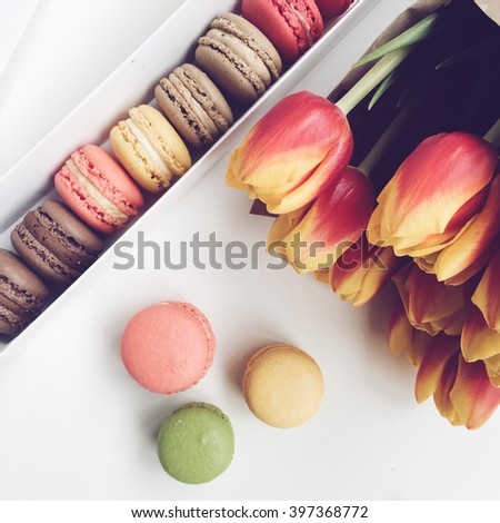 Macaroon and tulips on white background. Spring greeting card. iPhone 6s shooting