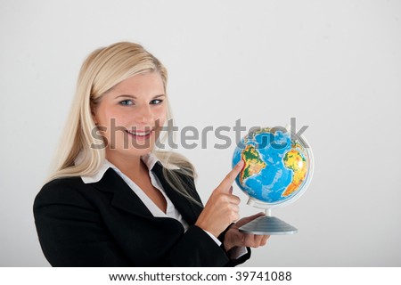 Young beautiful optimistic office business woman with a globe