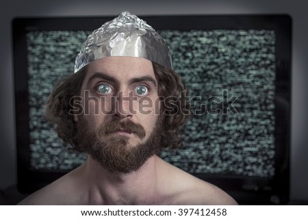 Brain washed crazy man is hypnotized by television program Royalty-Free Stock Photo #397412458