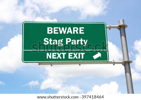 Green overhead road sign with a Beware Stag Party Next Exit concept against a partly cloudy sky background.