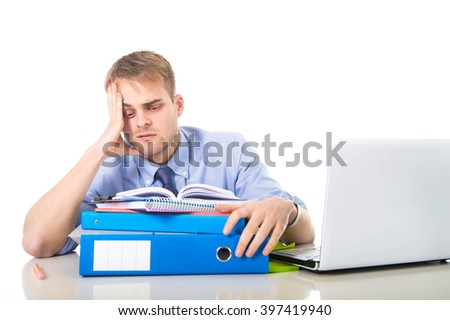 young overworked and overwhelmed businessman in sad and stress face expression reading office folder pile looking exhausted and depressed in business long hours working concept