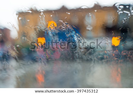 Blurred picture of traffic through a car windscreen during heavy rain.
