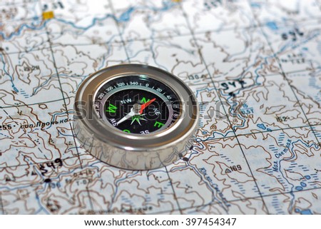 The compass on the map. Magnetic compass is located on a topographic map.