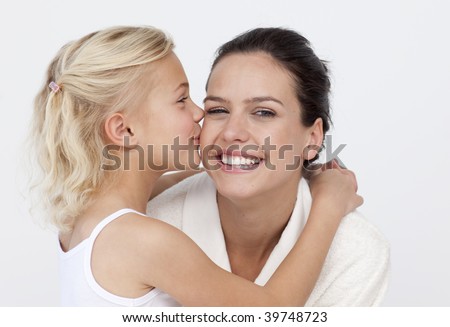 Portrait of daughter  kissing her mother in bathroom