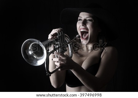 trumpet and a woman musical instrument beautiful young woman shadows valves and tubes