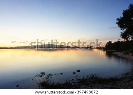 Silhouette image of colorful sky colorful water in lake and mountain before sunrise in the morning:Unfocused image:Ideal use for background.
