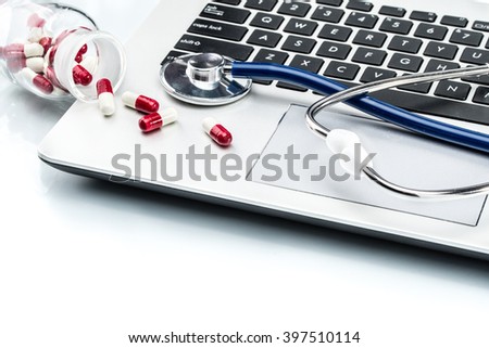 Medical Research, stethoscope and Capsule on laptop keyboard, doctor workplace