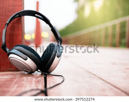 Headphone with sunlight on walk way wood