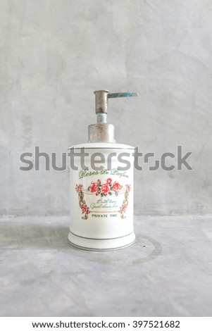 Vintage Bottle Of Liquid Soap, isolated on concrete wall background, health care and hygiene concept