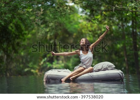 A hidden place. Sleeping woman in deep forest lies on airbed Royalty-Free Stock Photo #397538020