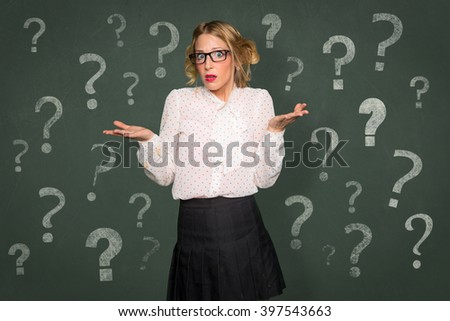 Conceptual question mark symbol confused baffled overwhelmed helpless woman nerdy classroom chalkboard