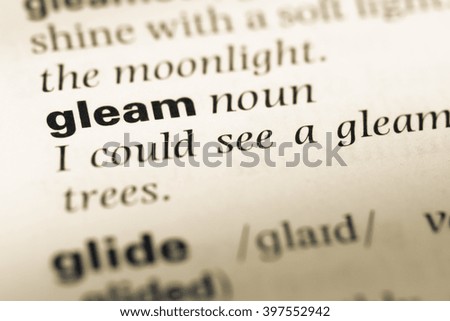 Close up of old English dictionary page with word gleam