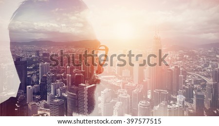 Closeup photo of stylish bearded banker wearing glasses and looking city. Double exposure, panoramic view contemporary megalopolis background. Space for your business message. Wide, sunset effect Royalty-Free Stock Photo #397577515