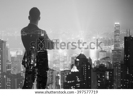 Photo of stylish adult businessman wearing trendy suit and looking night city. Double exposure, panoramic view contemporary City background. Horizontal, bokeh, blurred. Black ,white
