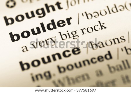 Close up of old English dictionary page with word boulder
