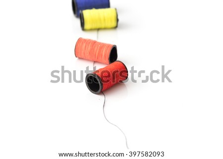 multicolor threads laying on black thread on white background best for sewing idea Royalty-Free Stock Photo #397582093