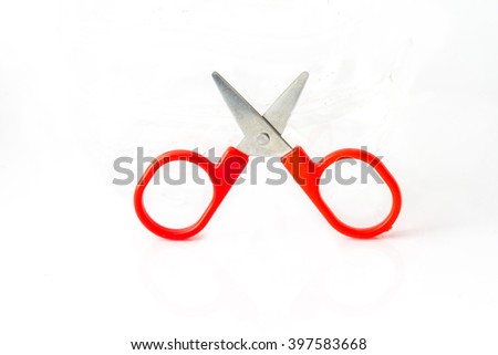 red scissors put up on white background Royalty-Free Stock Photo #397583668