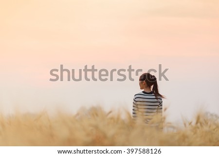  girl in wheat field with soft sunset