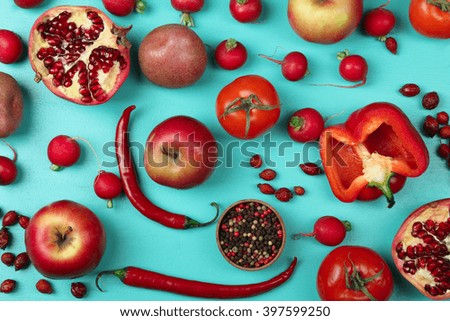 fruits and vegetables red flower scattered on blue wooden background