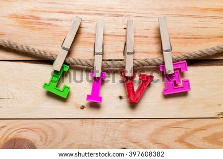Wooden clothes pin and colorful words series on rope