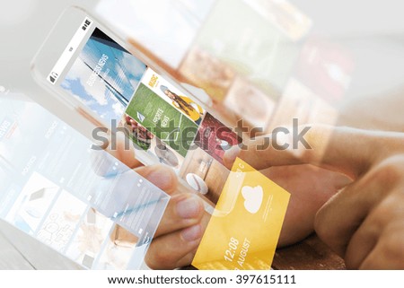 business, technology, mass media and people concept - close up of male hand holding transparent smartphone with internet news web page on screen Royalty-Free Stock Photo #397615111